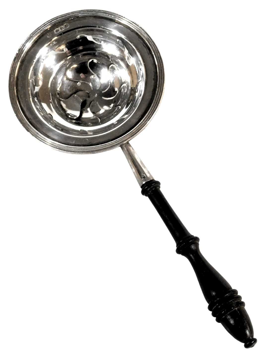Lot 105 - A George V silver tea strainer, with a turned...