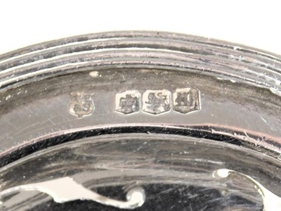 Lot 105 - A George V silver tea strainer, with a turned...