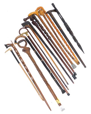 Lot 70 - A group of African carved walking sticks, with...