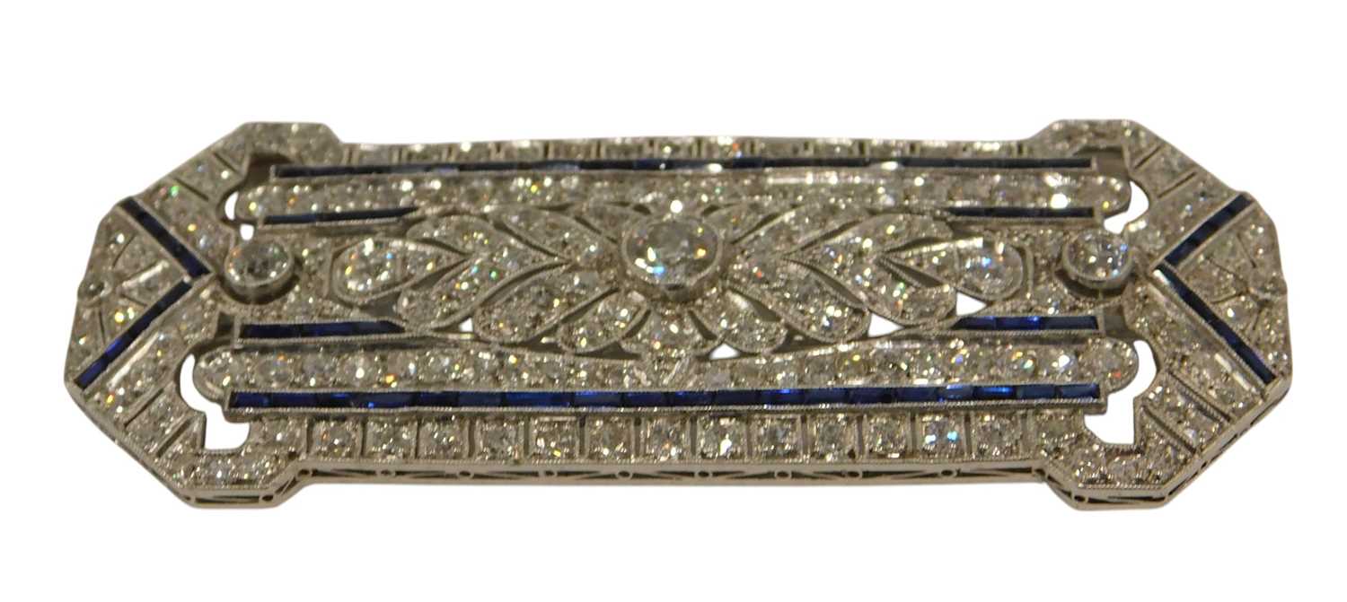 Lot 59 - An Art Deco diamond and sapphire panel brooch,...