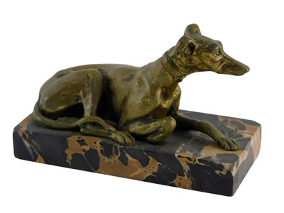 Lot 194 - A gilt metal model of a seated greyhound, on a...