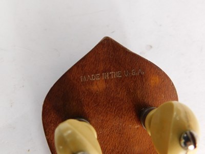 Lot 20 - A walnut and mother of pearl inlaid ukulele...