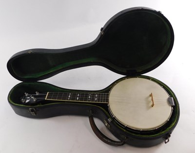 Lot 20 - A walnut and mother of pearl inlaid ukulele...