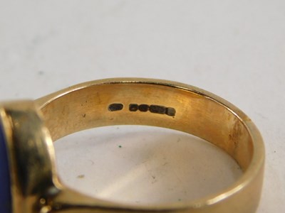 Lot 80 - A 9ct gold and lapis lazuli ring, in an ovoid...