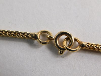 Lot 100 - A 9ct gold and coral pendant necklace, carved...