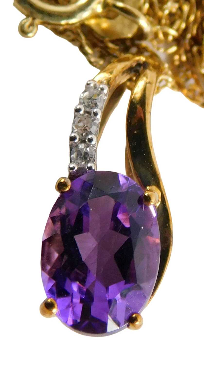 Lot 55 - A 9ct gold amethyst and diamond pendant, with...