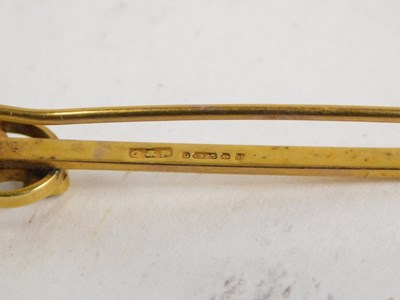 Lot 50 - A 9ct gold ruby and seed pearl bar brooch,...