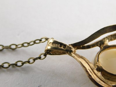 Lot 51 - A 9ct gold and opal pendant, on a fine link...