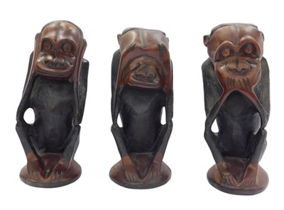 Lot 371 - Three hardwood carvings, modelled as Hear No...