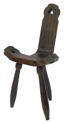 Lot 541 - A carved elm birthing chair, raised on turned...
