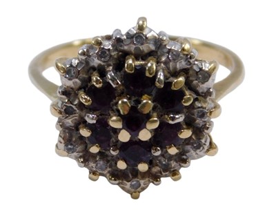 Lot 134 - A floral cluster dress ring, the central panel...