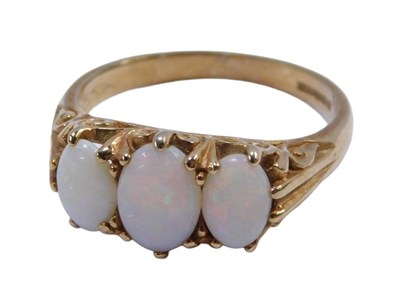 Lot 568 - A 9ct gold and opal dress ring, set with three...