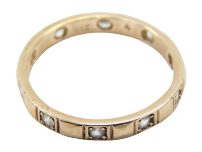 Lot 791 - An eternity ring, set with cz stones, yellow...