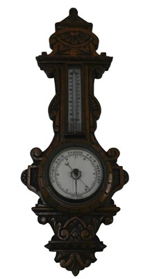 Lot 821 - A late Victorian carved oak aneroid barometer,...