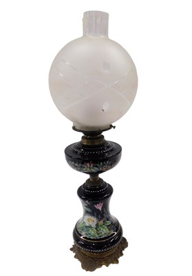 Lot 453 - A Victorian ceramic oil lamp, on a black...