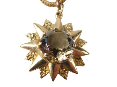Lot 78 - A 9ct gold pendant and chain, the brushed star...
