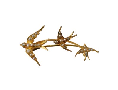 Lot 740 - A yellow metal brooch, raised with swallows...