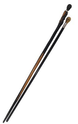 Lot 815 - Two walking sticks, comprising a carved tribal...