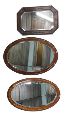 Lot 816 - Three 20thC wall mirrors, comprising two oval...