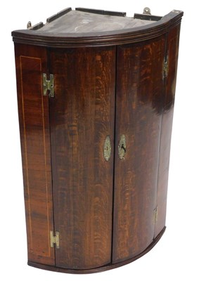 Lot 1040 - An early 19thC oak and mahogany bow fronted...