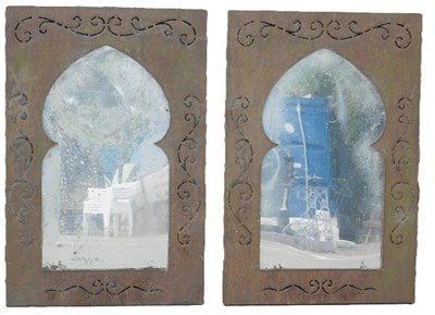 Lot 1082 - A pair of iron garden wall mirrors in Persian...