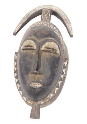 Lot 218 - A Baule tribal mask, Ivory Coast, 40cm high.