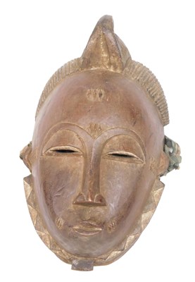 Lot 229 - A Baule tribal mask, Ivory Coast, 30cm high.