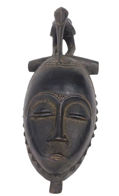 Lot 238 - A Baule tribal mask, Ivory Coast, 40cm high.