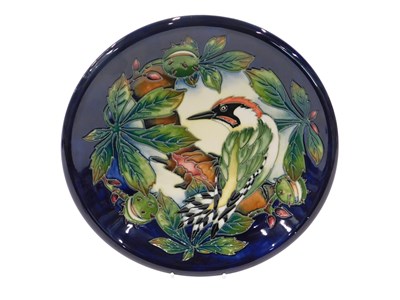 Lot 19 - A Moorcroft pottery plate, on a dark blue...