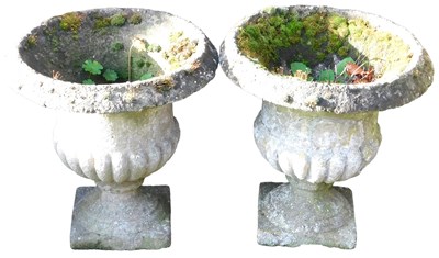 Lot 201 - A pair of reconstituted stone semi fluted...