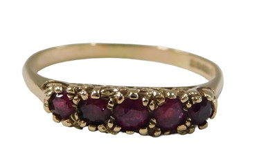 Lot 79 - A 9ct gold five stone garnet dress ring, AG...