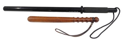 Lot 407 - An MP660 solid truncheon, 66cm wide, together...