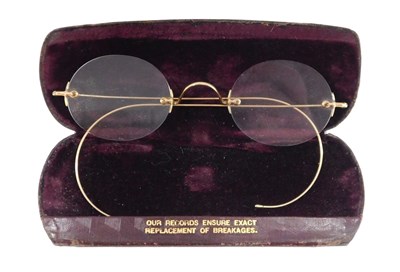 Lot 480 - A pair of gilt spectacles, with oval lenses...