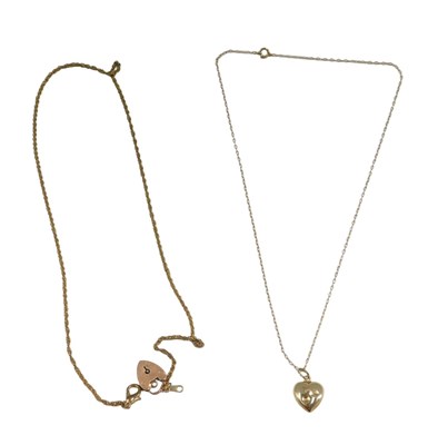 Lot 494 - A seed pearl heart pendant and chain, the...