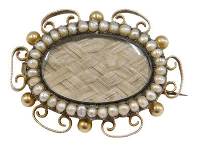 Lot 496 - A Victorian memorial brooch, the central oval...