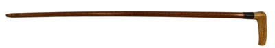 Lot 504 - A walking stick, with turned wooden handle,...
