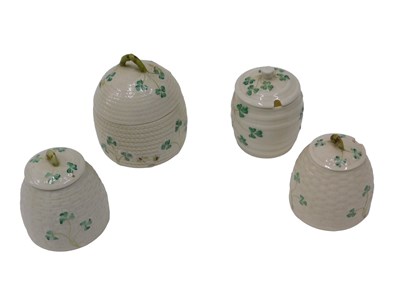 Lot 602 - Three Belleek porcelain beehive shaped...