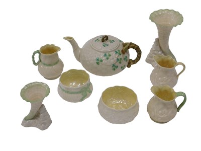 Lot 614 - A Belleek Shamrock pattern teapot, a third...