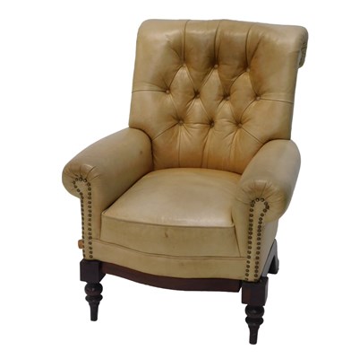 Lot 654 - A beige leather upholstered armchair, with a...