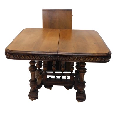Lot 657 - A Continental walnut extending dining table,...