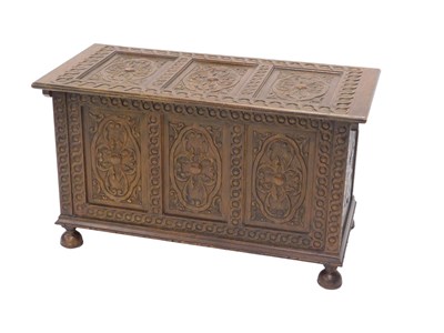 Lot 663 - A carved oak coffer, the three panel top...