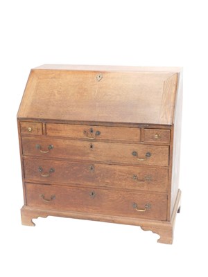 Lot 704 - A George III oak bureau, the hinged fall...
