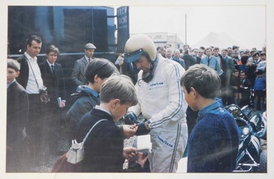 Lot 38 - A framed photographic print of Jack Brabham,...