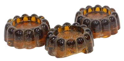 Lot 119 - A set of three Victorian moulded amber glass...