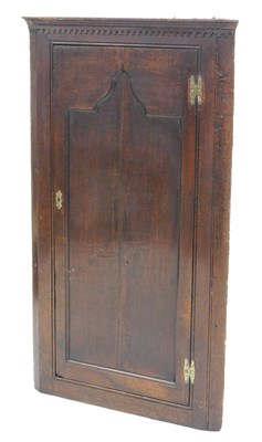 Lot 61 - A George II oak hanging corner cupboard, with...