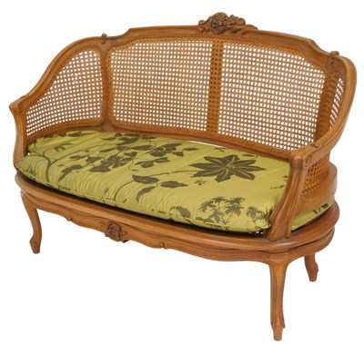 Lot 86 - A French walnut boudoir sofa, with ascroll...