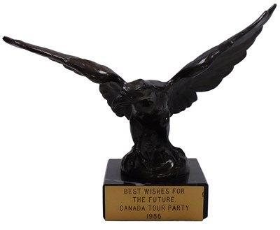 Lot 40 - A cast metal figure of an eagle, raised on a...
