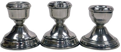 Lot 177 - Three Elizabeth II loaded silver candlesticks,...
