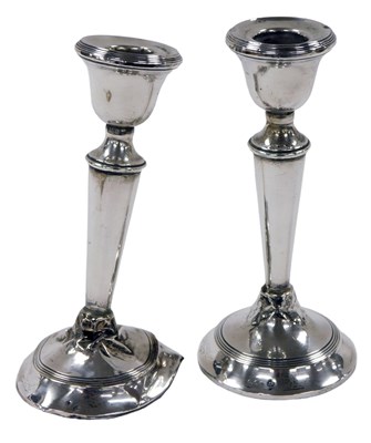 Lot 216 - A pair of George V loaded silver candlesticks,...