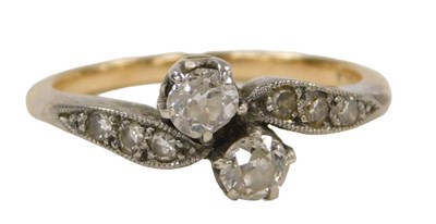 Lot 283 - A two stone diamond cross over ring, with...